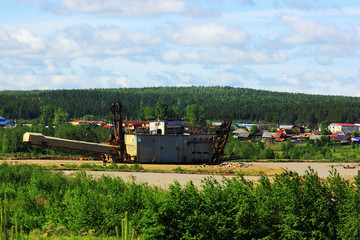 Fototapeta premium Old dredge on the river near a small forest village