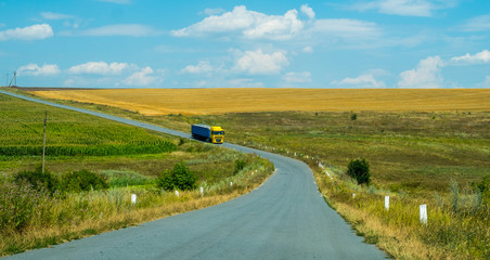 Cargo truck on a country road against a agricultural fields, Ukraine