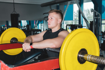 athlete paused between sets of barbell exercises