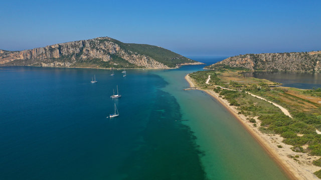 Aerial drone photo of iconic sandy beach of Divari (chrysi akti) with emerald sea near island of Sfaktiria in bay of Navarino, Messinia, Gialova, Peloponnese, Greece