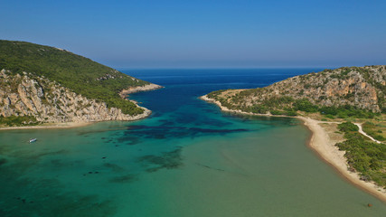 Fototapeta na wymiar Aerial drone photo of iconic secluded sandy beach with emerald sea in island of Sfaktiria next to bay and famous beach of Divari (chrysi akti), Messinia, Gialova, Peloponnese, Greece