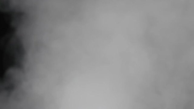 Slow motion of water vapor comes from below over black background