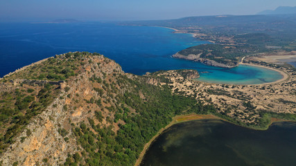 Fototapeta na wymiar Aerial drone view of semicircular sandy beach and lagoon of Voidokilia, one of the most iconic beaches in Mediterranean sea, with crystal clear turquoise sea, Messinia, Greece