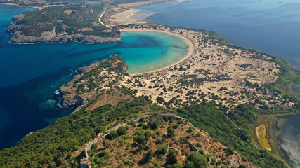 Fototapeta premium Aerial drone view of semicircular sandy beach and lagoon of Voidokilia, one of the most iconic beaches in Mediterranean sea, with crystal clear turquoise sea, Messinia, Greece