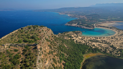 Aerial drone photo of iconic secluded sandy beach with emerald sea in island of Sfaktiria next to bay and famous beach of Divari (chrysi akti), Messinia, Gialova, Peloponnese, Greece