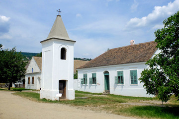 Fototapeta na wymiar Village street with a church