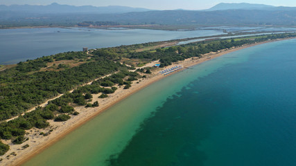 Fototapeta na wymiar Aerial drone photo of iconic sandy beach of Divari (chrysi akti) with emerald sea near island of Sfaktiria in bay of Navarino, Messinia, Gialova, Peloponnese, Greece