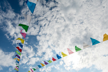 abstract photo of colorful ship flags over the blue sky