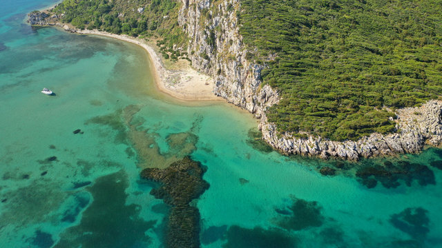 Aerial drone photo of iconic secluded sandy beach with emerald sea in island of Sfaktiria next to bay and famous beach of Divari (chrysi akti), Messinia, Gialova, Peloponnese, Greece