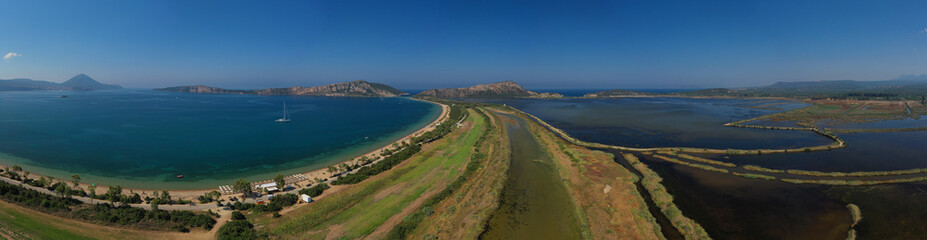 Aerial drone photo of iconic sandy beach of Divari (chrysi akti) with emerald sea near island of Sfaktiria in bay of Navarino, Messinia, Gialova, Peloponnese, Greece