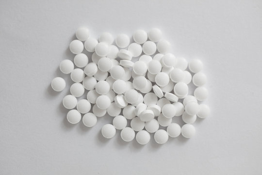 White tablets top view. Melatonin medicine.