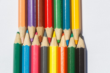 Fototapeta premium Colored wooden pencils on white background