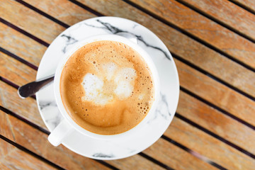 Top view of hot coffee on the wood table 