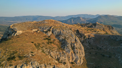 Aerial drone panoramic view of iconic uphill medieval castle of Acrocorinth an ancient citadel overlooking ancient Corinth, Peloponnese, Greece