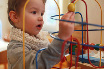 Boy playing with bead maze toy