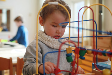Boy playing with bead maze toy