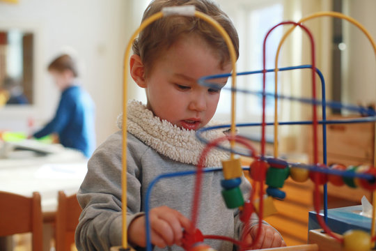 Boy playing with bead maze toy