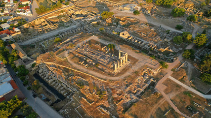 Fototapeta premium Aerial drone photo of iconic archaeological site of Ancient Corinth featuring temple of Apollo built in the slopes of Acrocorinth, Peloponnese, Greece