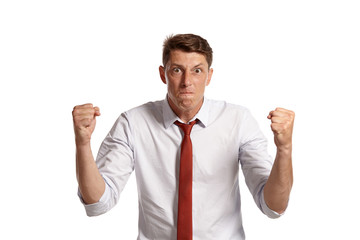 Portrait of a young brunet man posing in a studio isolated over a white background.