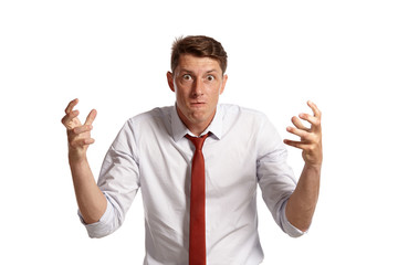 Portrait of a young brunet man posing in a studio isolated over a white background.