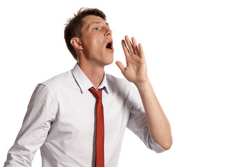 Portrait of a young brunet man posing in a studio isolated over a white background.