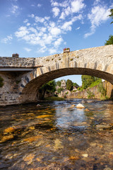 Fototapeta premium View of the river bridge and the village church Audressein in the department of Ariège, in the Pyrenees, Occitanie region, France