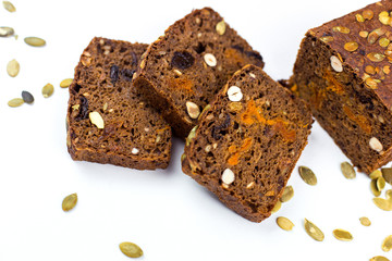 Bread with nuts and dried fruits, prunes, dried apricots, raisins and seeds on isolated white background
