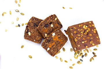 Bread with nuts and dried fruits, prunes, dried apricots, raisins and seeds on isolated white background