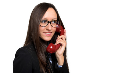 Young female manager on a red vintage phone