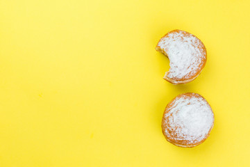 Donut with sugar isolated on yellow background. Top view