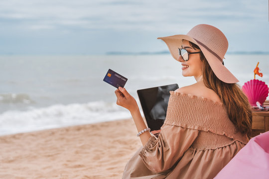Woman use credit card  at the beach in holidays