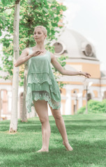 Young ballerina dancing in city streets, feeling breath of big city life and freedom 