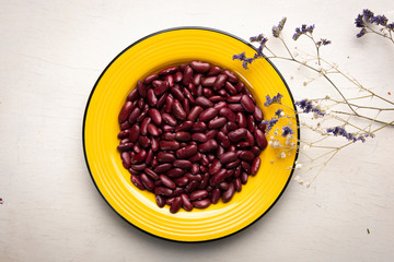 Dry red beans in the plate on the table