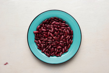 Dry red beans in the plate on the table