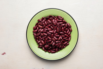 Dry red beans in the plate on the table
