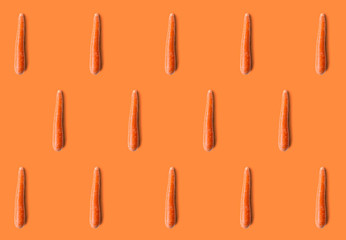 Carrot pattern isolated on orange background. Fresh diet food..