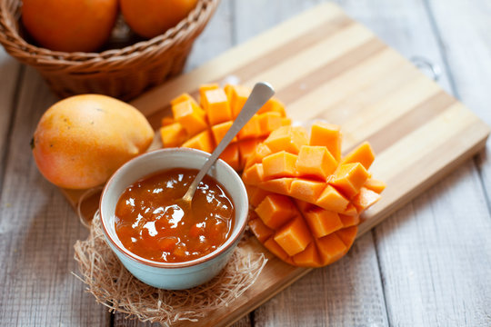 Homemade mango jam on wooden background