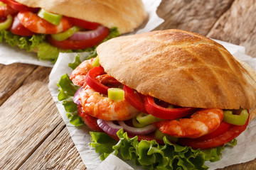 Fresh pita with king prawns, vegetables close-up on parchment. horizontal
