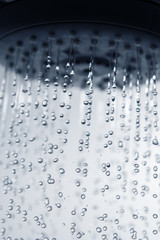 Fototapeta na wymiar Falling water drops from shower head.
