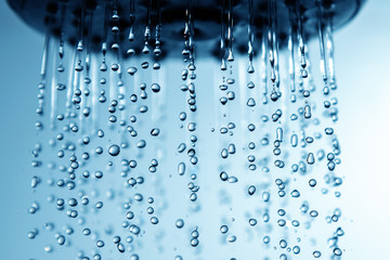 Falling water drops from shower head.