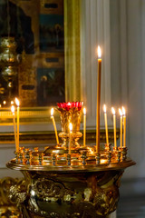 Large church candlestick with burning candles in orthodox church