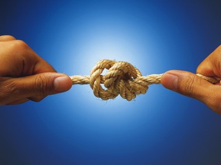 hand with rope on blue background