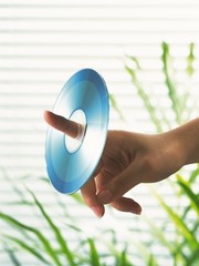 hand with CD