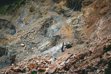 The working machine breaks the stone in the quarry