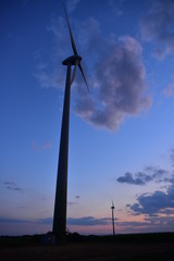 Fototapeta na wymiar Wind turbines for green energy generation at dusk in Burgenland.