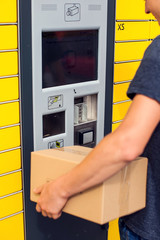 Client using automated self service post terminal machine or locker to deposit a parcel for storage