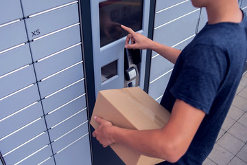 Client using automated self service post terminal machine or locker to deposit a parcel for storage