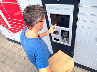 Client using automated self service post terminal machine or locker to deposit a parcel for storage