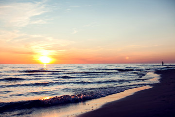 A sunset on the beach. Sea and eveninig sky with clouds