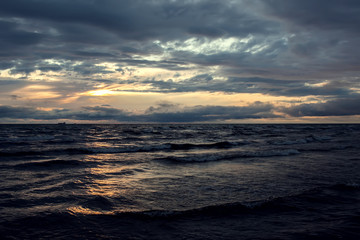 A sunset on the beach. Sea and eveninig sky with clouds